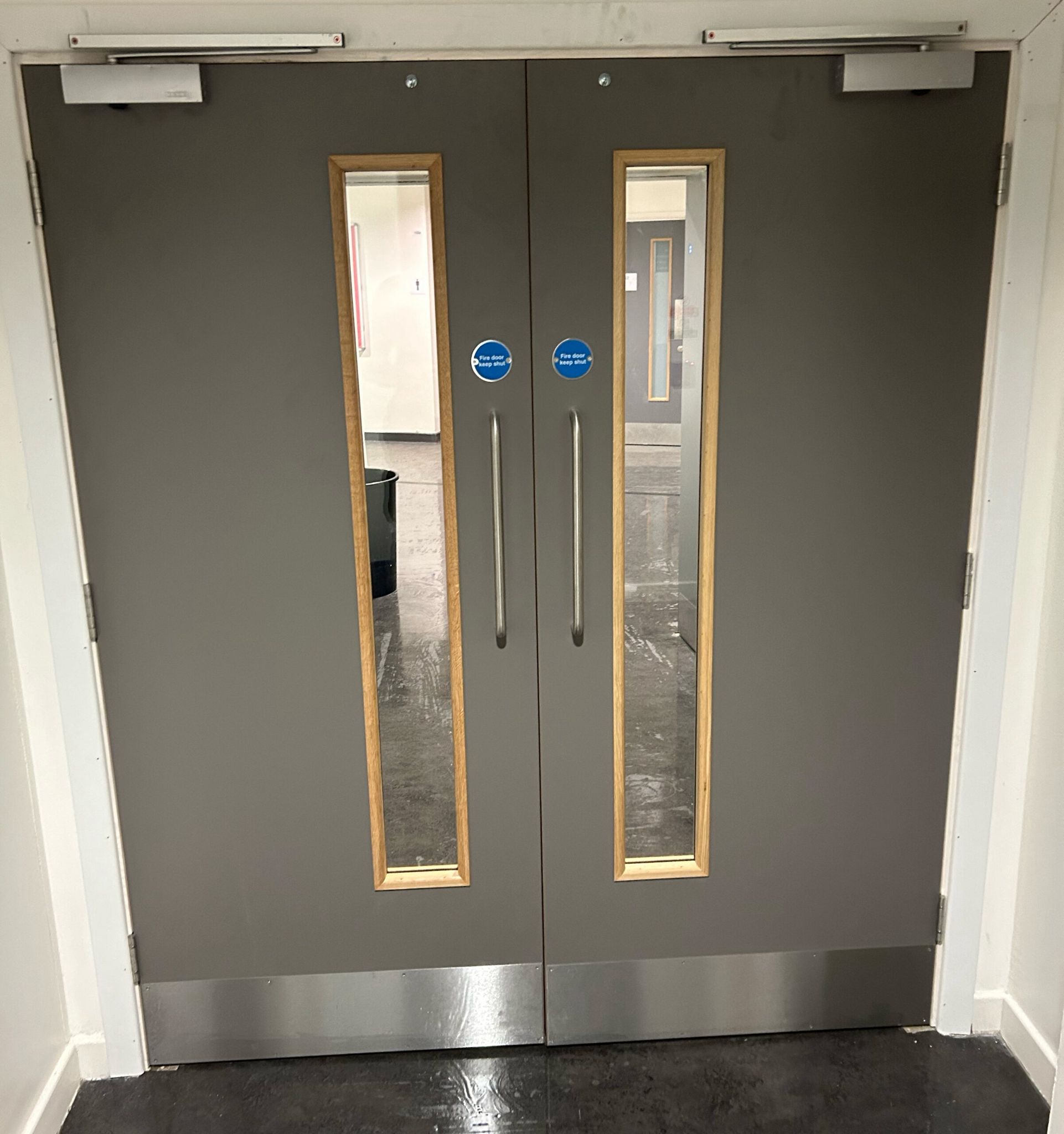 Grey double doors with timber vision panels