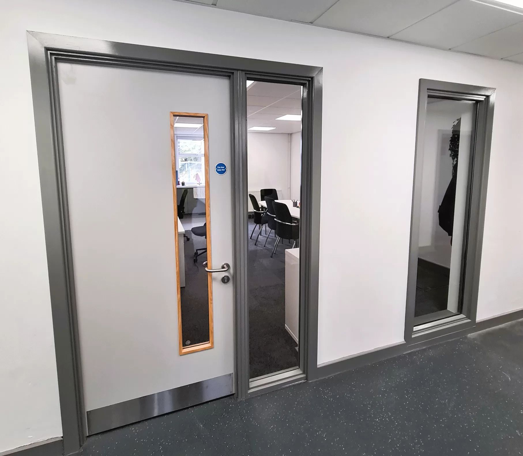 Grey office fire doors with vision panels