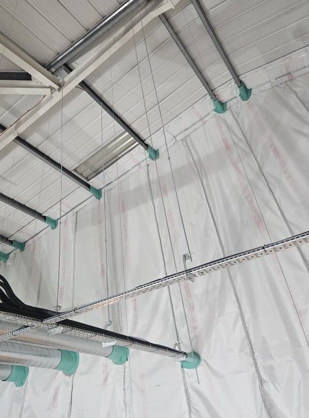 Suspended fire barrier curtains in commercial warehouse