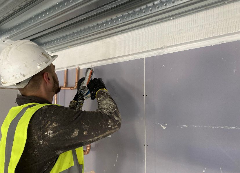 Fitting fire-rated boards with intumescent strip